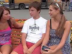 Two adorable chicks pleasing a guy in the park