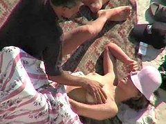 Horny dude fucks his sleeping wife on a beach. Spy cam clip